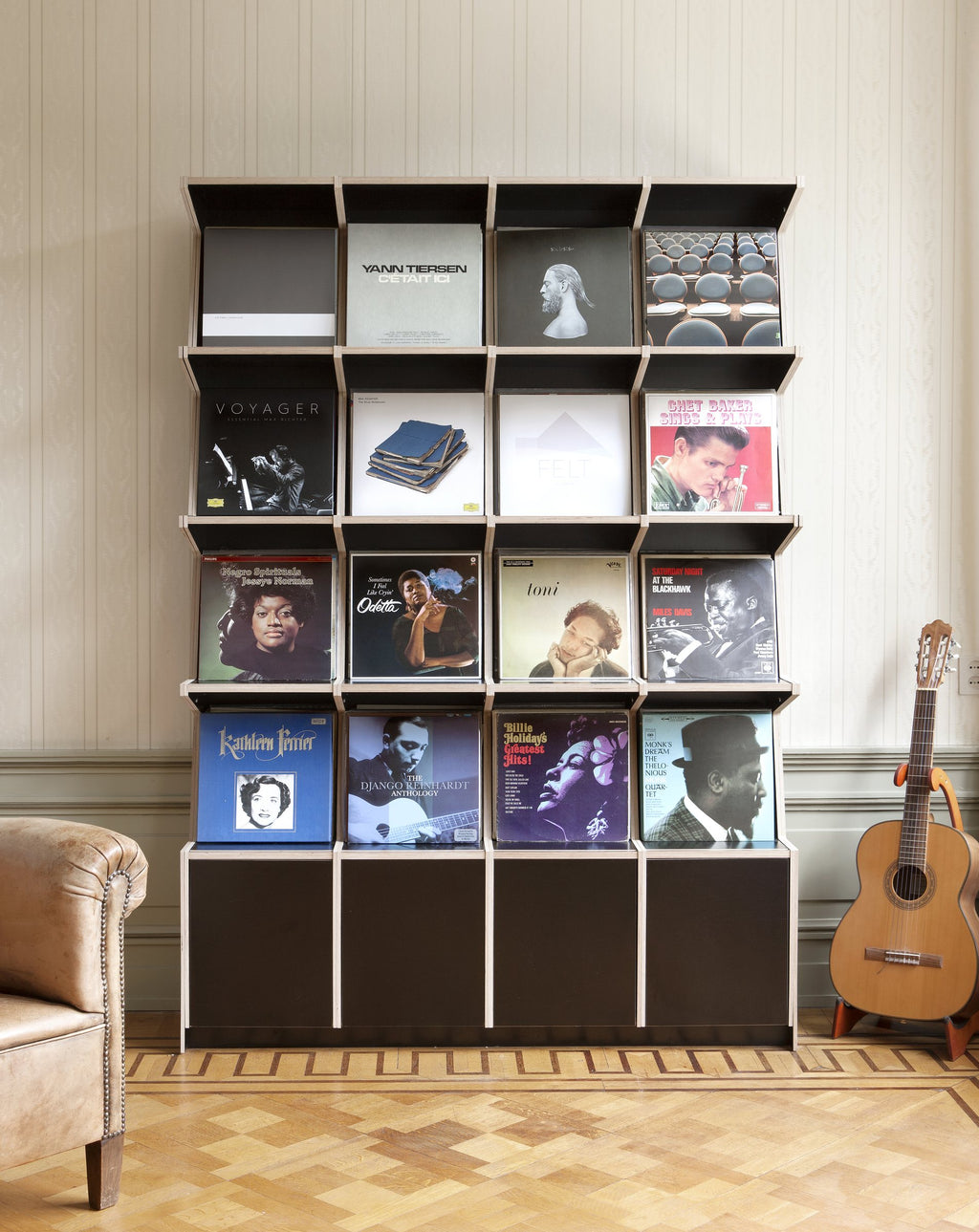 Coverfront record cabinet in black birch plywood, four wide and four high, in a classic living room