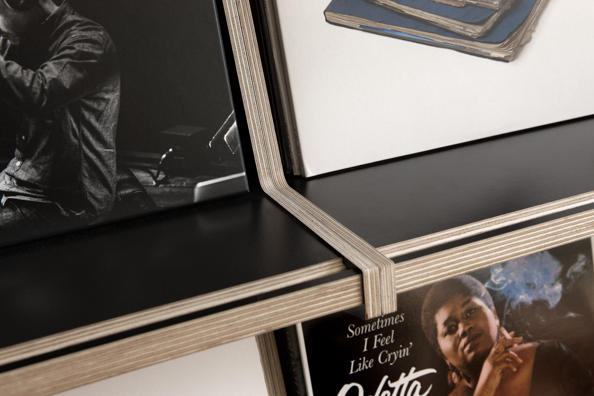 Detail of the birch plywood edge against the black panel of a Coverfront record cabinet