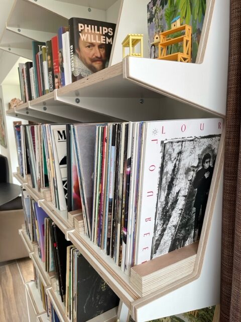 Ophon Coverfront record cabinet in birch plywood, white, four columns, four compartments high, with records standing cover-forward