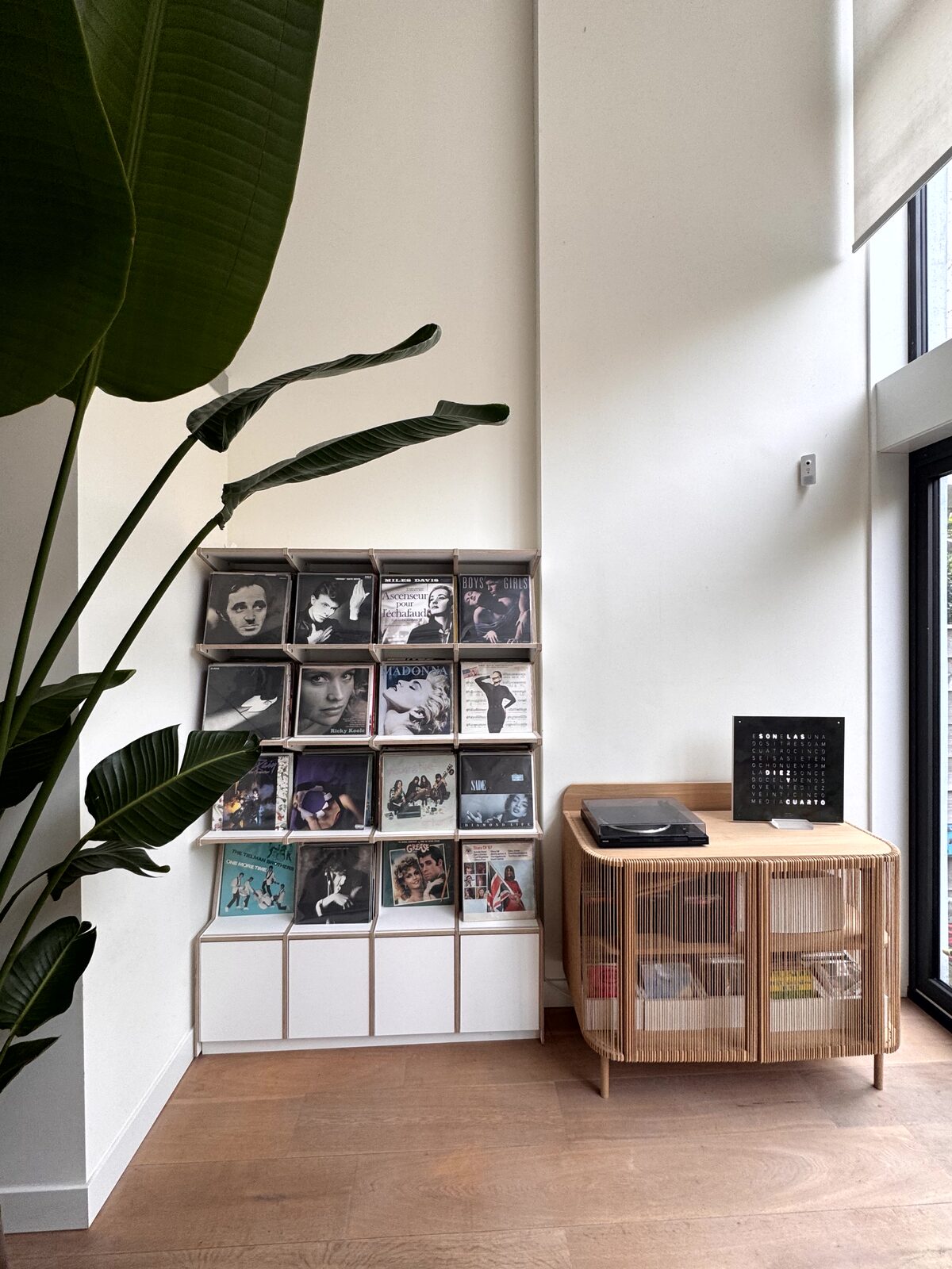 Ophon Coverfront record cabinet in birch plywood, white, four columns, four compartments high, with records standing cover-forward
