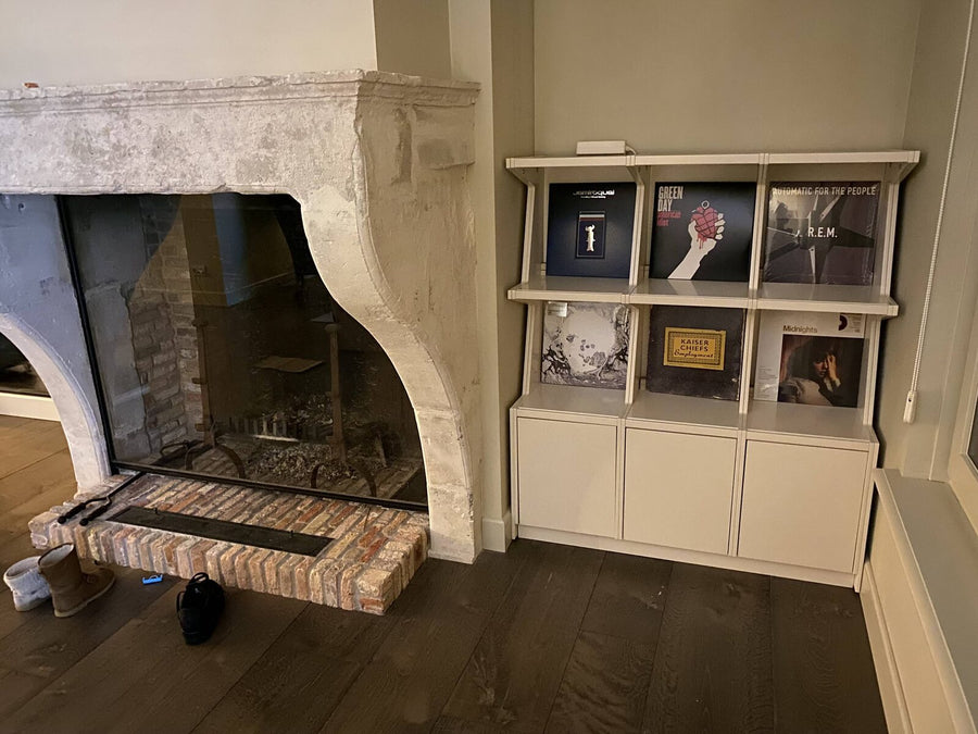 Low and wide beside an old stone fireplace.