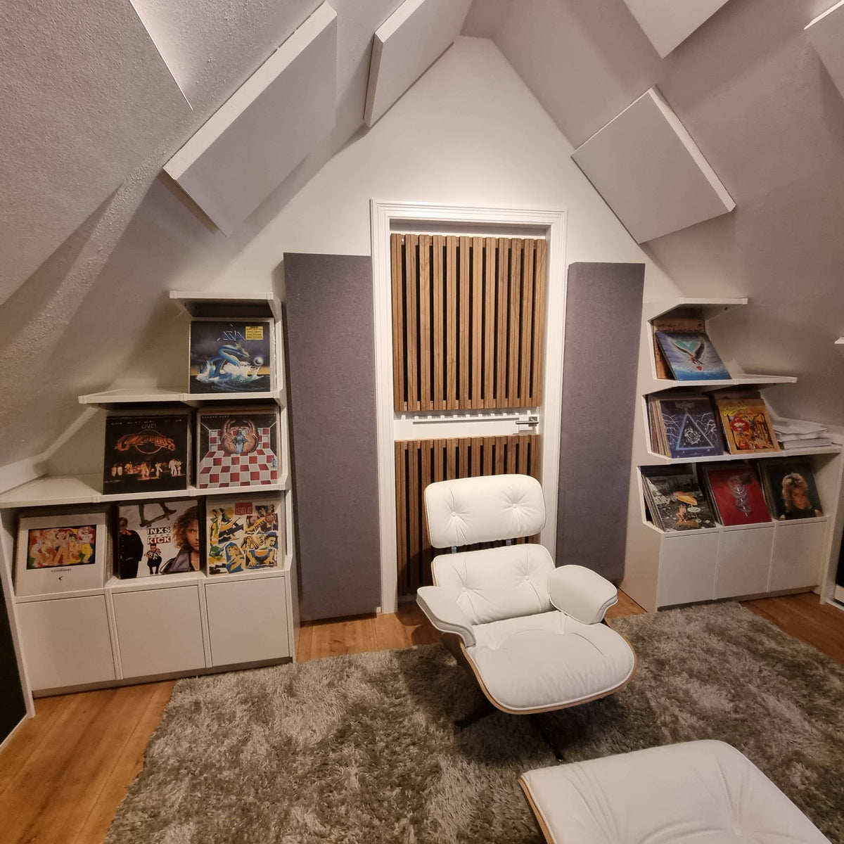 Two stepped Coverfronts under the sloping roof of an attic listening room