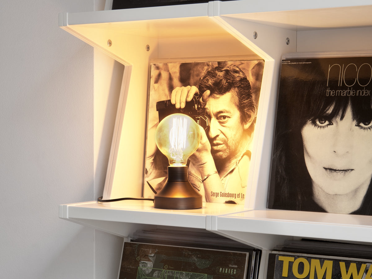 Close-up of a white spray-painted Coverfront with a lamp in one compartment